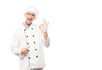 Surprised young chef with a gesture of approval
