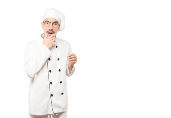 Astonished young chef with a gesture of shock