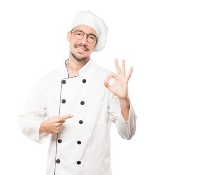 Happy young chef doing an all right gesture