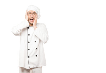 Crazy young chef making a gesture of despair