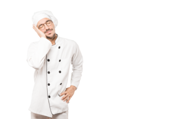 Relaxed young chef making a gesture of sleep