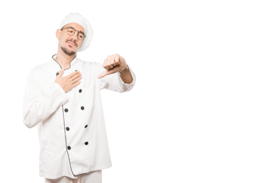 Serious young chef doing a gesture of defeated