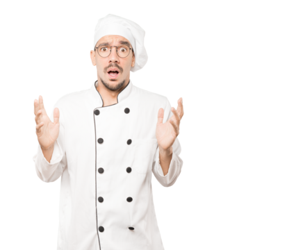 Crazy young chef making a gesture of despair