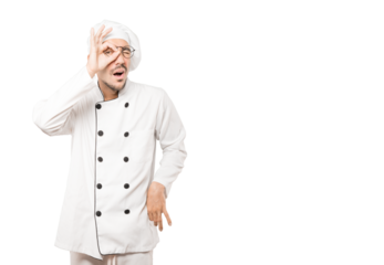Happy young chef using his hands like a binoculars
