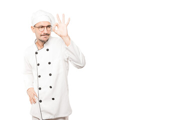 Amazed young chef using his hands like a binoculars