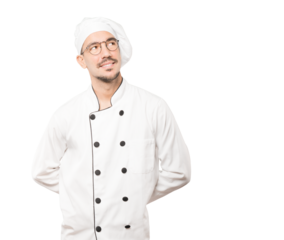 Happy young chef looking against background