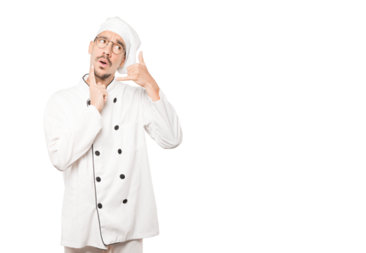 Hesitant young chef making a gesture of calling with the hand