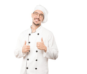 Happy young chef gesturing that everything is fine