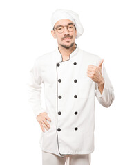 Hesitant young chef gesturing that everything is fine