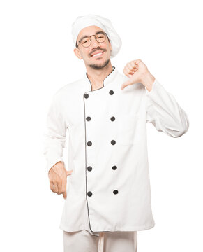 Proud young chef making a haughty gesture