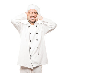 Young chef worried about loud noises and covering his ears
