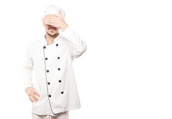 Young chef covering his eyes with his hands