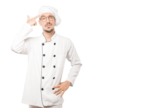 Depressed young chef making a suicide gesture