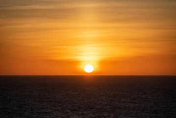 Beautiful, golden sunset over the calm ocean.
