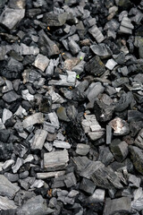 selective focus of pile of dried wood charcoal 
