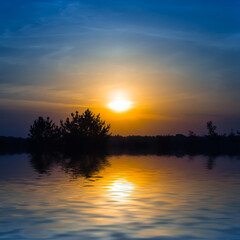 dramatic sunset over the small quiet lake, evening natural background