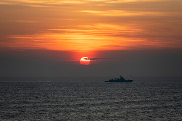 Fototapeta premium Beautiful, golden sunset over the Taiwan Strait calm sea.