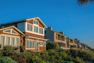 Fototapeta na wymiar Beach side houses against clear blue sky at Del Mar Southern California.