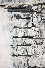 a fragment of a wall with cracks and peeling plaster, selective focus