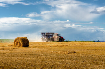 tractor field harvest wheat rolls sky beautiful view clouds summer season hay straw agriculture harvesting