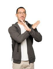 Student making a gesture of not crossing with the arms
