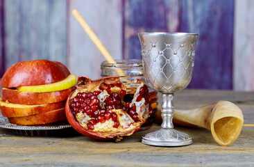 Traditional Jewish New Year symbols include apple, honey, pomegranate and shofar during the Jewish...