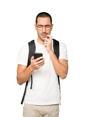 Confused student using a mobile phone