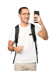 Happy student taking a selfie with his mobile phone