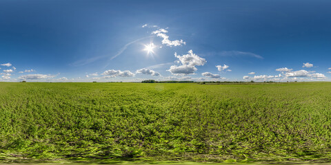 full seamless 360 hdri panorama view among farming field with sun and clouds in overcast sky in equirectangular spherical projection, ready for use as sky replacement in drone panoramas or VR content