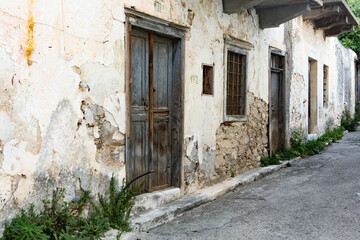 Fototapeta na wymiar Narrow and colorful street in the village of Kritsa in the island of Crete. White street, beautiful traditional housing in Greece. 