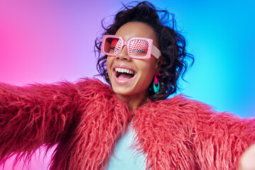 Beautiful African woman in trendy clothes making selfie and smiling against colorful background