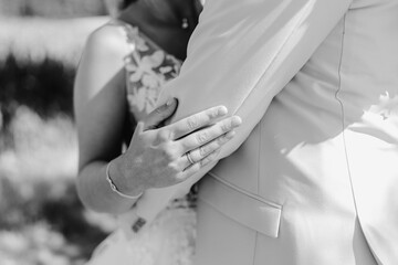 Bride's hand close-up on groom's arm