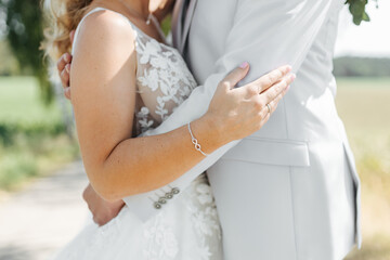 Bride's hand close-up on groom's arm