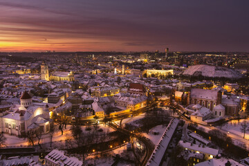 Fototapeta na wymiar Beautiful Vilnius city panorama in winter with snow covered houses, churches and streets. Aerial evening view. Winter city scenery in Lithuania.