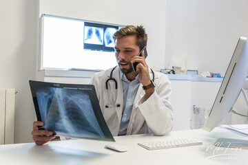 pulmonologist Doctor looks at a chest x-ray - clinic medical concept