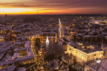 Beautiful Vilnius city panorama in winter with snow covered houses, churches and streets. Aerial evening view. Winter city scenery in Lithuania.