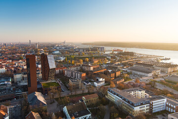 Scenic aerial view of the Old town of Klaipeda, Lithuania in golden evening light. Klaipeda city port area and it's surroundings on autumn day.