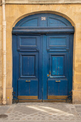 Fototapeta na wymiar Paris, France. August 2022. Old entrance door to courtyard of building.