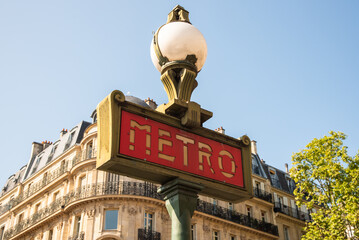 Paris, France. August 2022. Traditional Paris metro sign with buildings in the background