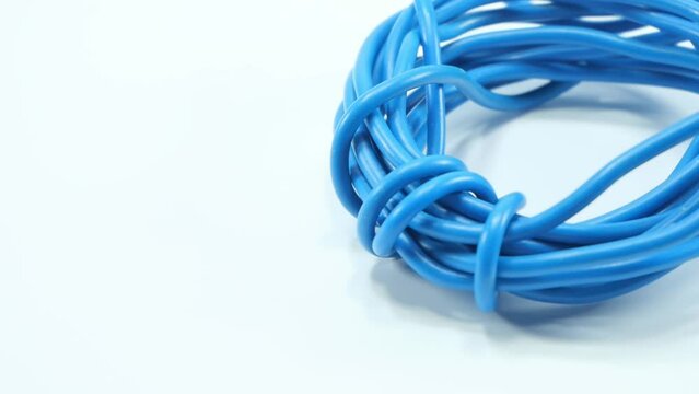 Blue wire cable of usb and adapter isolated on white background.Electronic Connector.Slow motion footage moving from right to left.Macro vdo.Selection focus.