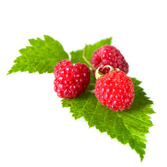 Raspberries with leaves isolated on a white background