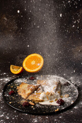 Crepes stuffed with orange marmalade with shortbread ice cream and powdered sugar