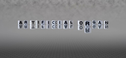 artificial organ word or concept represented by black and white letter cubes on a grey horizon...