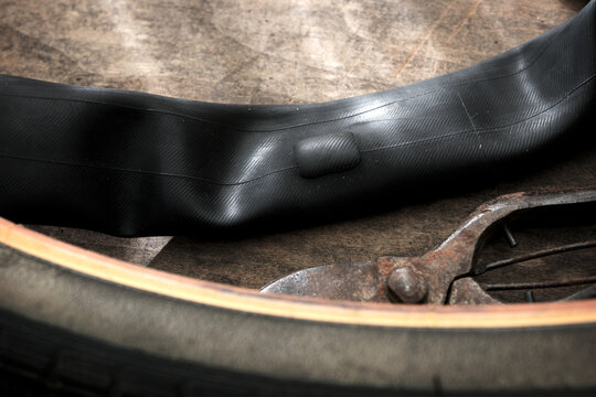 Patch up. Patching. Repairing a flat tire of an bicycle tire. Patched up inner tube of an bicycle tire. Rustic feel.