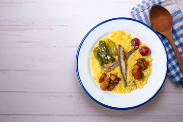 Migas de la Alpujarra. Breadcrumbs. Typical Spanish tapa recipe made with flour, anchovies, chorizo, bacon, peppers and grapes.