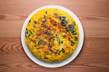 Spinach and potato omelette. Traditional Spanish tortilla recipe. Top view shot.