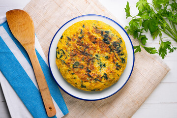 Spinach and potato omelette. Traditional Spanish tortilla recipe. Top view shot.