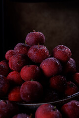 Full plate of fresh red apples. A lot of ripe apples in the bowl and around it.