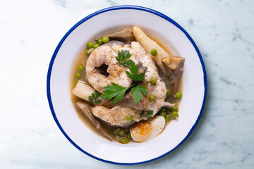 Conger eel with white asparagus and egg. Traditional Spanish tapas from a fishing village.