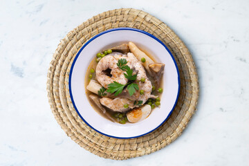 Conger eel with white asparagus and egg. Traditional Spanish tapas from a fishing village.